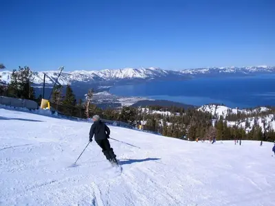 a man is skiing down a snow covered slope at Lakeside Studio Steps from the Beach in Tahoe Vista