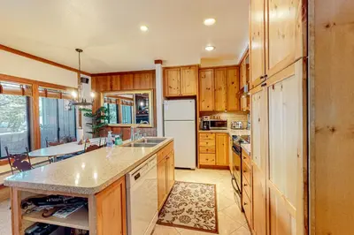 a kitchen with wooden cabinets and a counter top at Mountain Time Escape in Olympic Valley