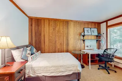 a bedroom with a bed and a desk and a desk at Mountain Time Escape in Olympic Valley