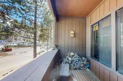 a bench on the side of a house with a window at Mountain Time Escape in Olympic Valley