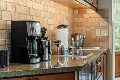 a kitchen counter with a sink and a coffee maker at Everline Resort & Spa 701 & 703 in Olympic Valley