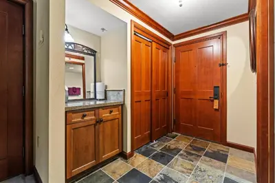a bathroom with a sink and a wooden door at Everline Resort & Spa 701 & 703 in Olympic Valley