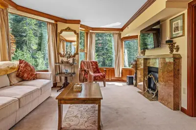 a living room with a couch and a fireplace at Everline Resort & Spa 701 & 703 in Olympic Valley