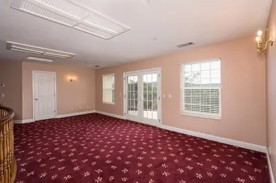 an empty living room with a red carpet at Yosemite South Presidential Mansion in Coarsegold
