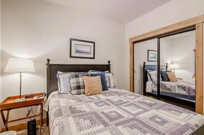 a bedroom with a large bed and a mirror at Tahoe Discovery in South Lake Tahoe