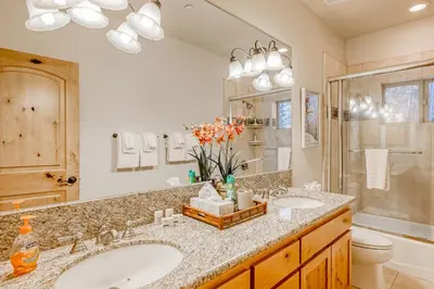 a bathroom with two sinks and a shower at Tahoe Discovery in South Lake Tahoe