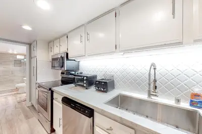 a kitchen with white cabinets and a sink at Mountain Shadows H6 in Mammoth Lakes