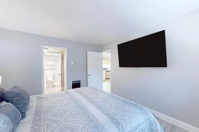 a bedroom with a bed and a tv on a wall at Mountain Shadows H6 in Mammoth Lakes