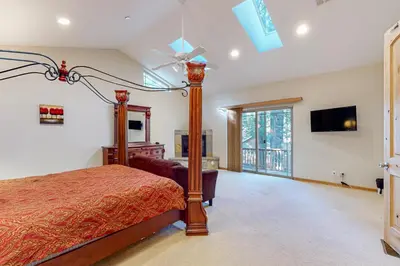 a bedroom with a bed and a ceiling fan at Heavenly Lake Hideaway in South Lake Tahoe
