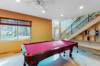 a red pool table in a room with stairs at Heavenly Lake Hideaway in South Lake Tahoe