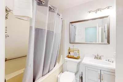 a bathroom with a toilet and a sink and a mirror at Tranquil Haven Retreat - DSTR1068 in Stateline