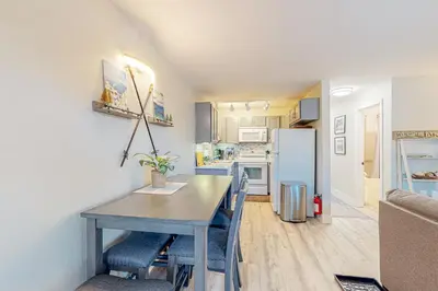 a kitchen and dining room with a table and a refrigerator at Tranquil Haven Retreat - DSTR1068 in Stateline