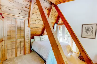 a bedroom with a bed in a log cabin at The Regal Bear in Homewood