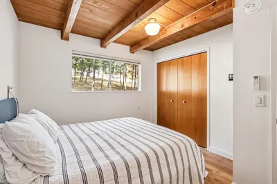 a bedroom with a bed and a window at Marina Beach Cabin - Dog-Friendly Home with Deck! home in Groveland