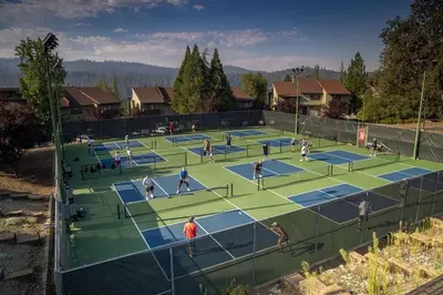 a group of people playing tennis on a tennis court at Marina Beach Cabin - Dog-Friendly Home with Deck! home in Groveland
