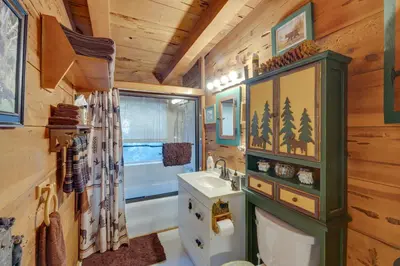 a bathroom with a sink and a toilet in a cabin at Creekside Cabin By Calaveras Big Trees State Park in Camp Connell