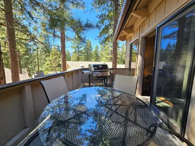 a glass table on the balcony of a house at Cozy Bear Lodge home in Incline Village