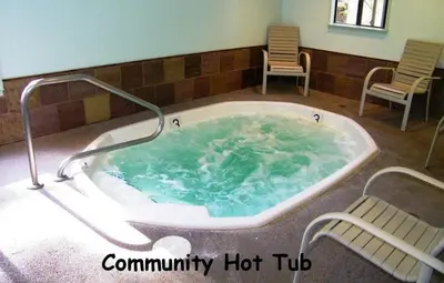 a hot tub with two chairs in a room at Pinenut Place home in Incline Village