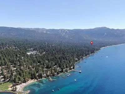 a hot air balloon flying over a lake with trees at Pinenut Place home in Incline Village