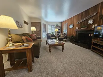 a living room with a couch and a table at Pinenut Place home in Incline Village