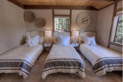 a bedroom with two beds and two windows at Inclining View home in Incline Village