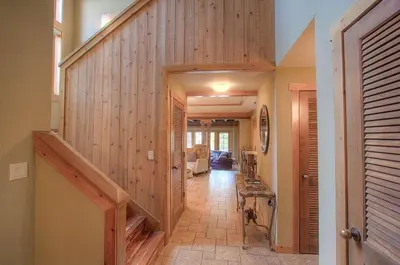a hallway with a wooden wall and a stairway at Third Creek Comfort townhouse in Incline Village