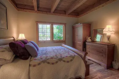 a bedroom with a bed and a dresser and a mirror at Third Creek Comfort townhouse in Incline Village