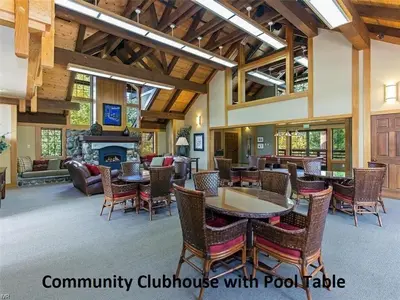 a living room with tables and chairs and a fireplace at Third Creek Comfort townhouse in Incline Village