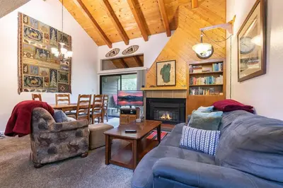 a living room with a couch and a fireplace at 2BR Townhome Walk to Beach or Trails in Carnelian Bay