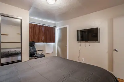 a bedroom with a bed and a flat screen tv at Tyrolean Village 6 2 Bedroom 1 and a Half Bath Sleeps 6 Walk to Lift Steps to town shuttle in Mammoth Lakes