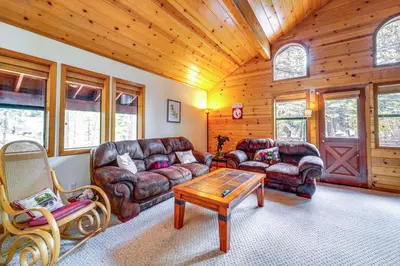 a living room with leather furniture and a wooden ceiling at Deck with Hot Tub Serene Cabin in Truckee in Truckee