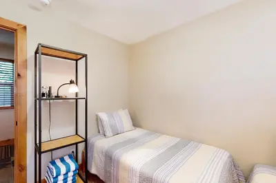 a small bedroom with a bed and a mirror at Kings Beach Retreat in Kings Beach