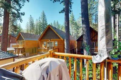 a log cabin in the woods on a deck at Kings Beach Retreat in Kings Beach