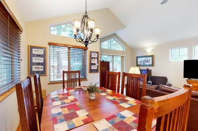 a dining room with a table and a couch at Kings Beach Retreat in Kings Beach