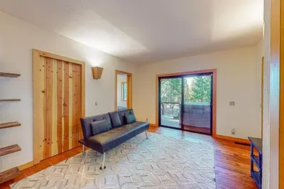 a living room with a couch and a sliding glass door at Epic Mountain Escape in Tahoe Vista
