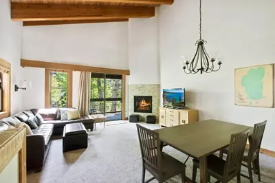 a living room with a table and a couch at Bright 2BDR Next to NorthStar - 5min Walk! in Truckee