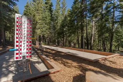 a sign in the middle of a park with trees at Bright 2BDR Next to NorthStar - 5min Walk! in Truckee