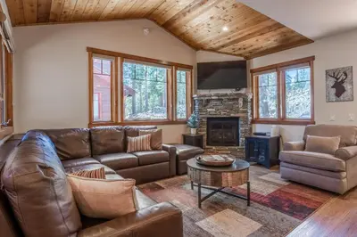 a living room with leather furniture and a fireplace at Grayfox #4 3 Bedroom 3 Bathroom Sleeps 8 Walk to Village Gondola in Mammoth Lakes