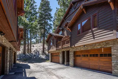 a house with wooden garage doors on it at Grayfox #4 3 Bedroom 3 Bathroom Sleeps 8 Walk to Village Gondola in Mammoth Lakes
