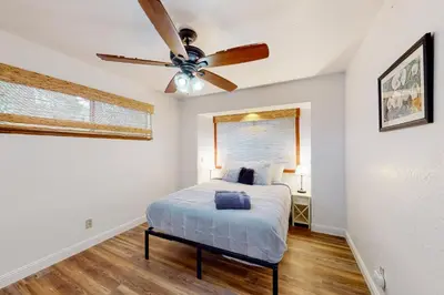 a bedroom with a bed and a ceiling fan at Cozy and Comfortable Yosemite Portal in Oakhurst