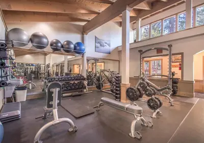 a gym with several tread machines and exercise bikes at Northstar Resort True Ski In Ski Out Year-Round Hot Tubs Book on Your Mobile for Promo Price in Truckee