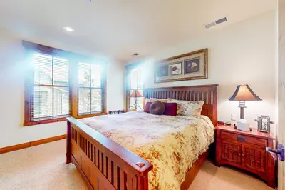 a bedroom with a bed and a night stand with a lamp at Lodges 1136 in Mammoth Lakes
