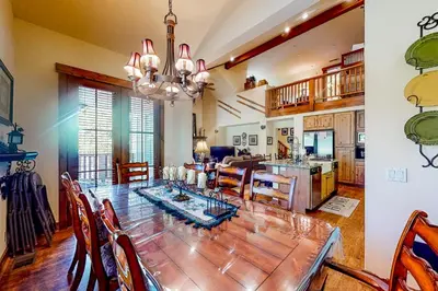 a dining room and kitchen with a large wooden table at Lodges 1136 in Mammoth Lakes