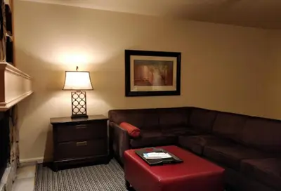 a living room with a brown couch and a table at GetAways at the Lodge at Kingsbury Crossing in Stateline