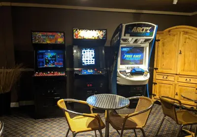 a table and chairs in a room with arcade machines at GetAways at the Lodge at Kingsbury Crossing in Stateline