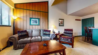 a living room with a couch and a coffee table at Summit #232 condo in Mammoth Lakes