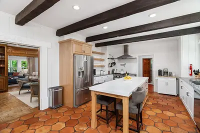 a kitchen with a table and some chairs in it at Grape Escape Inn & Suites in Lodi