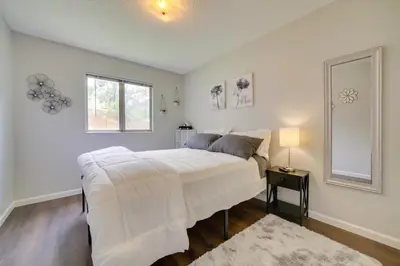a bedroom with a large white bed and a window at Centrally Located Reno Retreat with Patio and Yard in Reno
