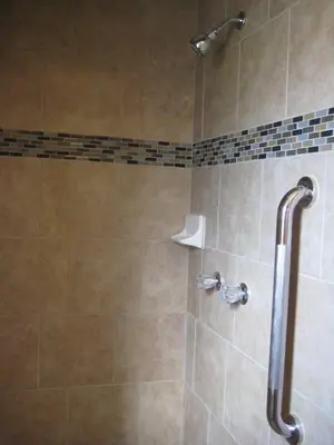 a bathroom with a shower with a tiled shower at Americas Best Value Inn - Porterville in Porterville