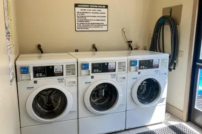 two washing machines sitting next to each other in a laundry room at St Moritz 9 in Mammoth Lakes